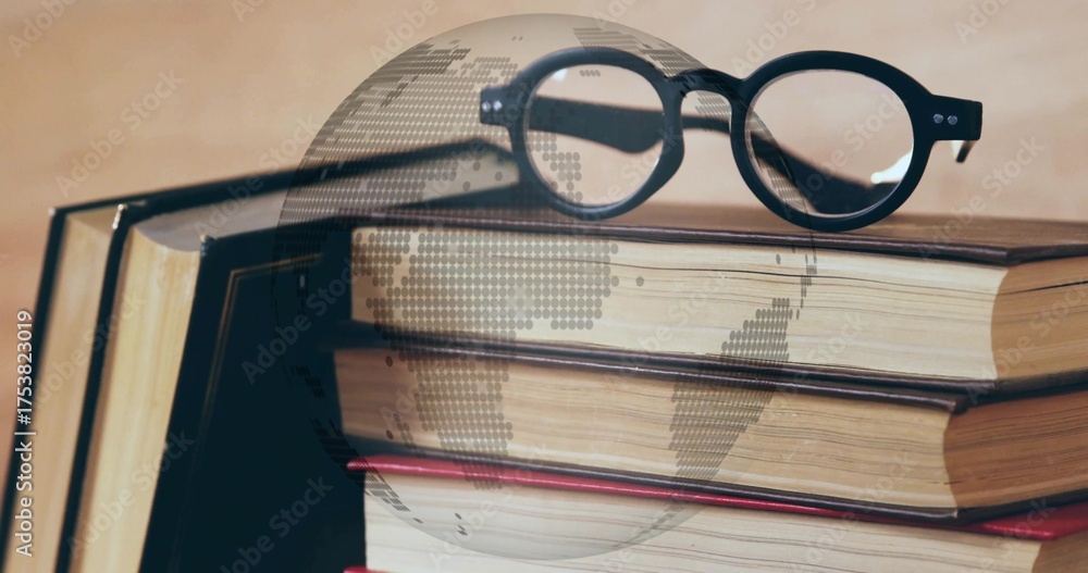 Fototapeta premium Resting black eyeglasses on hardcover book stack on desk, with digital globe overlay