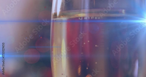 Opening closeup showing flute glass rising bubbles and sweeping lensflare emphasizing effervescence