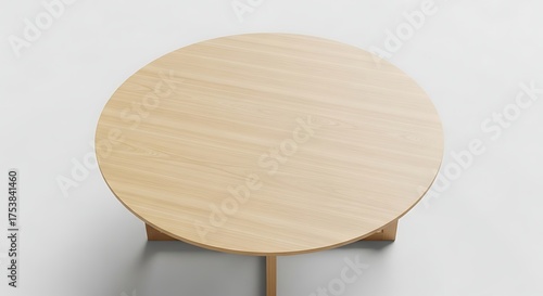 Overhead view of a simple, modern, round wooden table.