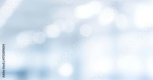 Abstract DSLR blurred business background in shades of white and light blue with subtle bokeh, creating a calm bright and professional atmosphere.