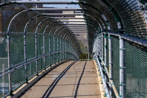 empty pedestrian bridge leading to city