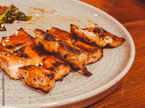 Beef steak is rarely found on a white plate. Wood pattern background. Top view.