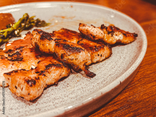 Beef steak is rarely found on a white plate. Wood pattern background. Top view.