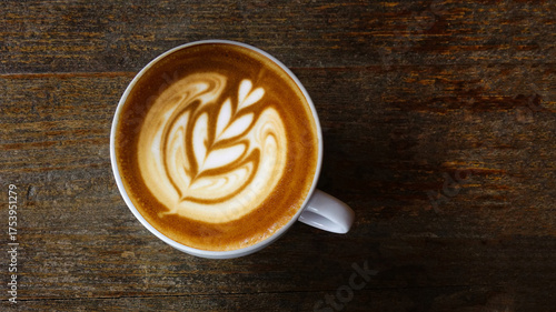  a cup of latte art coffee on wooden background                                                                                                                                                         