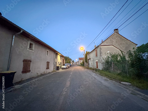 Wallpaper Mural Bergnicourt, Rethel, Ardennes, Grand-Est, France, August, 28th, 2025,A tranquil village street at dusk, softly illuminated by streetlights, capturing the essence of peaceful rural charm Torontodigital.ca