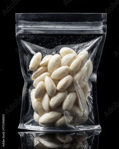 Almonds in Transparent Bag on Black Background