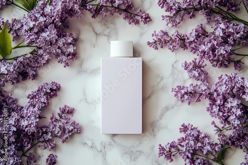 a plain pastel cosmetic bottle on a white marble surface surrounded by fresh lilac flowers. Clean, elegant composition for themes of skincare, fragrance, natural cosmetics, spring freshness 