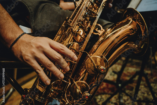 Close-up of male musician playing saxophone during jazz rehearsal
