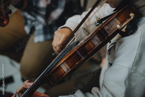 Close-Up of Violinist's Hands Playing the Violin in Orchestra Rehearsal