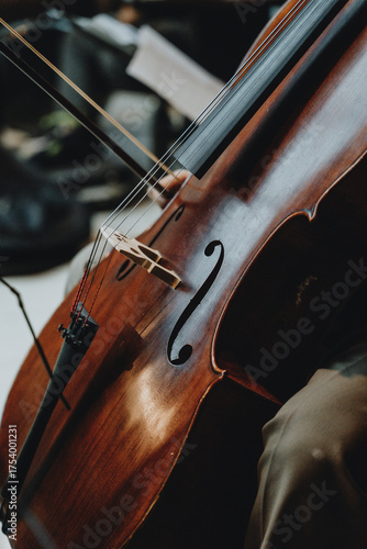 Close up detail of musician playing cello in orchestra rehearsal