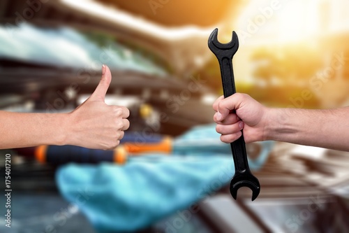 Wallpaper Mural Hands of mechanic holding tool and hand of client. Torontodigital.ca