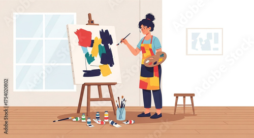 A female artist is painting an abstract artwork on a canvas in her studio, showcasing her creativity and passion