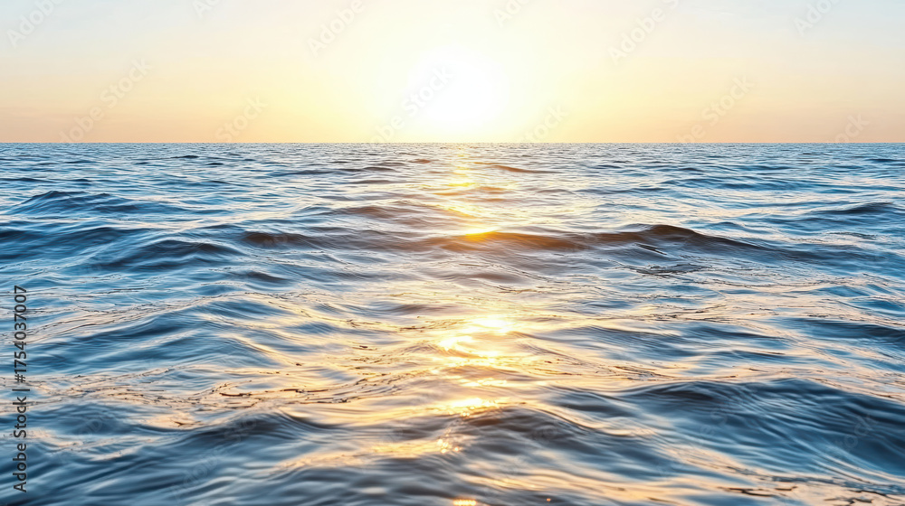 Obraz premium Calm sea with gentle waves reflecting sunset colors, creating serene atmosphere