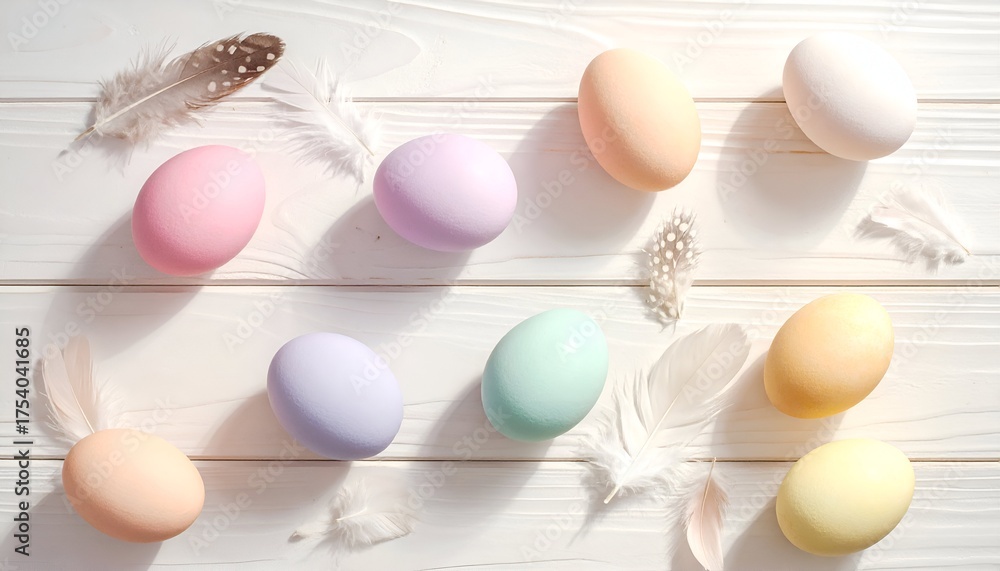 Fototapeta premium Colorful pastel eggs arranged with delicate feathers on a wooden surface, creating a serene spring atmosphere