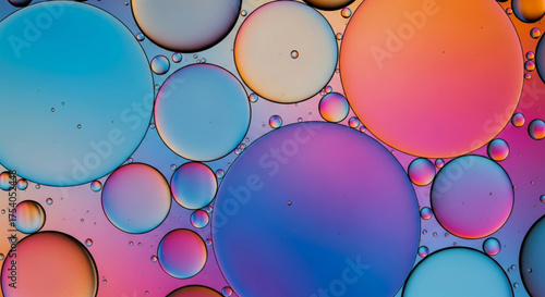 Closeup of vibrant oil droplets in water, creating a colorful and abstract pattern, perfect for artistic backgrounds and creative designs