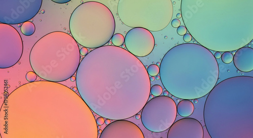 Macro photograph showcasing a mesmerizing display of colorful oil droplets suspended in water, creating an abstract and artistic visual texture