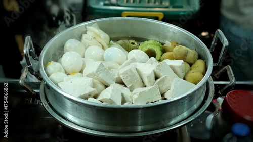 Steaming pan with tofu eggs and vegetables in street food stall