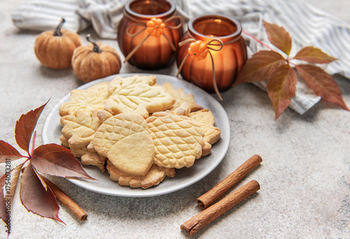 Autumn cookies on plate with cinnamon and fall decor