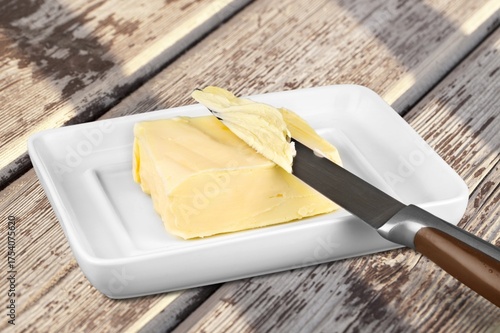 Fotografi Sliced pieces of fresh butter on a table,