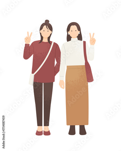 旅行先でSNS用に写真を撮る女性二人組 秋冬ファッションの女の子ベクター素材