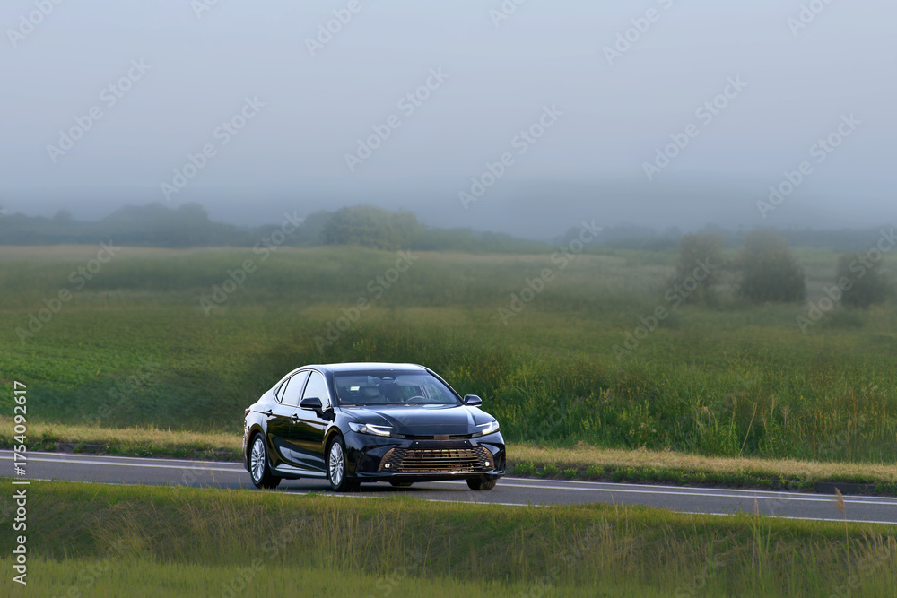 Fototapeta premium Shiny new automobile driving on open highway