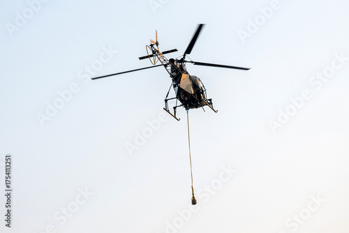 Helicopter rescue, flying on isolated blue sky in mid-air background