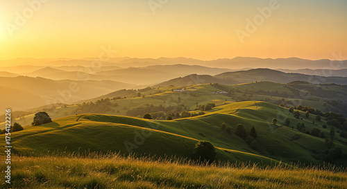 Fototapeta Naklejka Na Ścianę i Meble -  Golden hour paints a serene landscape of rolling hills and distant mountains, creating a peaceful and inviting vista at the end of the day.