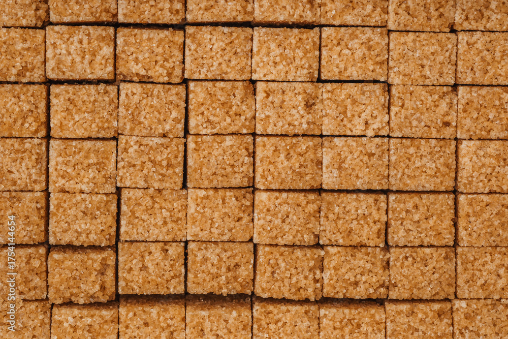 Fototapeta premium Brown sugar cubes arranged neatly on a flat surface for culinary use