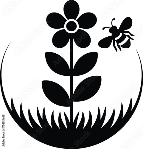 Silhouette of a bee pollinating a flower amidst green grass