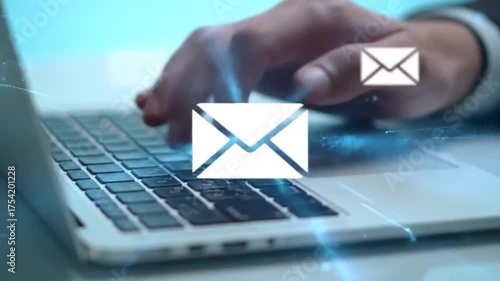 Hand typing on laptop keyboard with glowing email icon and digital communication effects overlay