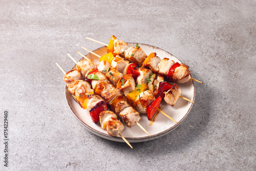 Grilled chicken skewers. Satay with side lemon and salad. Kebab with sauces. 