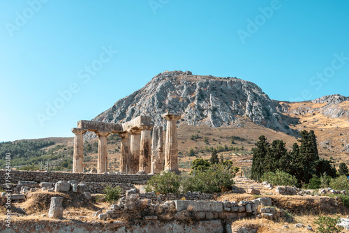 Majestic view of Acrocorinth mountain with the ruins of the Temple of Apollo in the foreground, Ancient Corinth, Greece.
