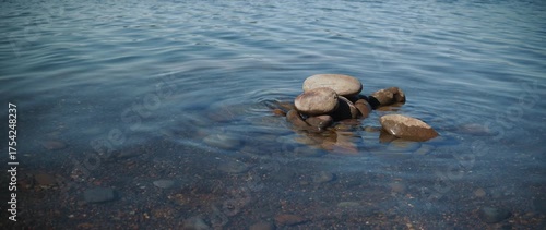 Stones in clear lake water in shallow area