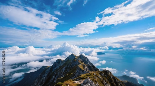 Majestic mountain peaks piercing through fluffy white clouds under a vibrant blue sky, evoking awe and serenity.