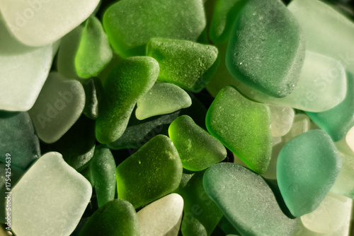 Canvas Print A rare heart-shaped piece of sea glass among soft green stones
