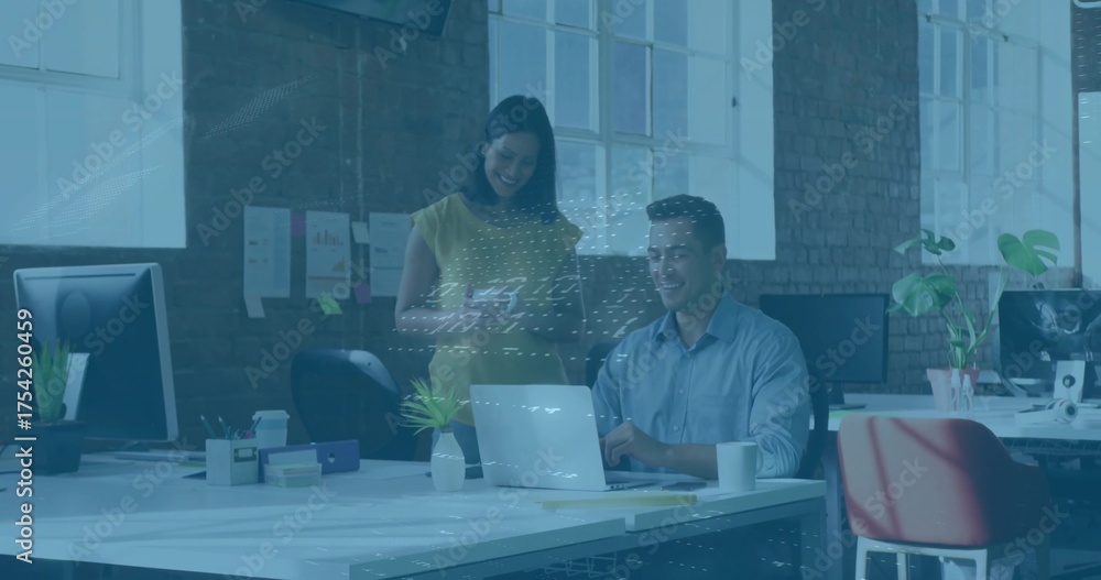 Obraz premium Collaborating colleagues discussing reports in open-plan office, with laptop smartphone