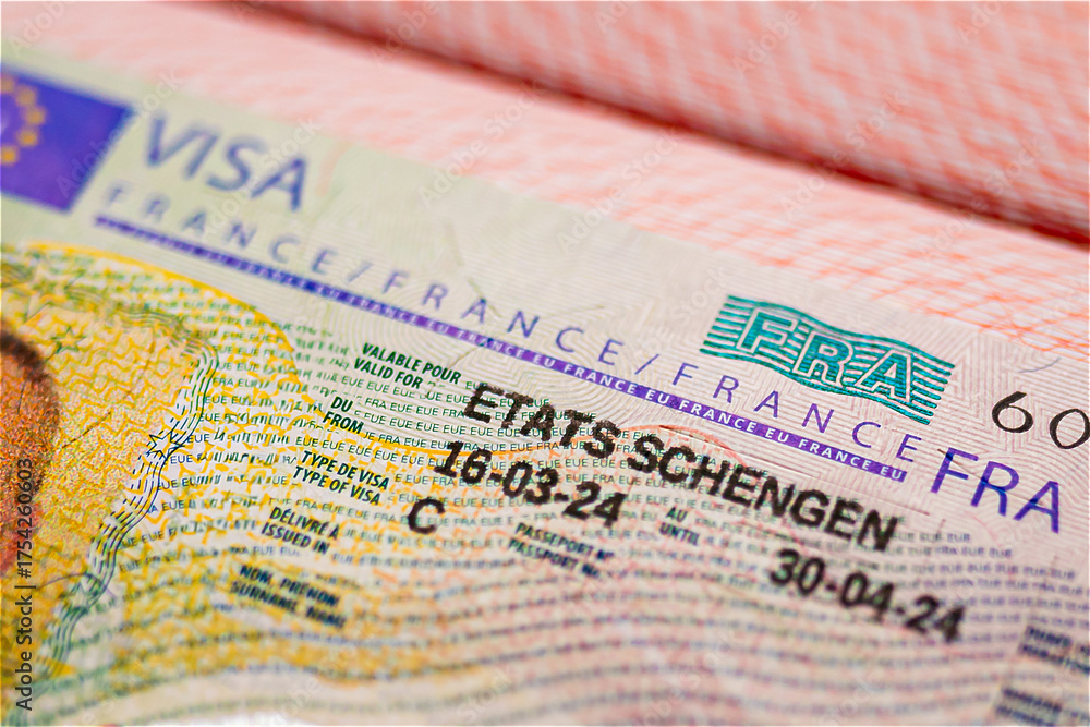 Fototapeta premium Schengen visa of France in passport, approved visit France and Europe. close-up