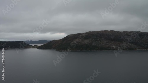 Wallpaper Mural Aerial drone footage capturing a Norwegian fjord under gloomy evening weather. The scene features calm, dark waters surrounded by misty mountains and low clouds, creating a moody and atmospheric view  Torontodigital.ca