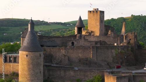bourscheid castle château de green valley cover hills behind walls towers views castle’s exterior structure to left right up close circling drone luxembourg 