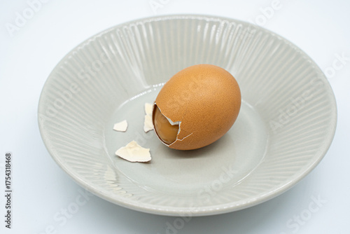Boiled eggs in a circular bowl on a white background