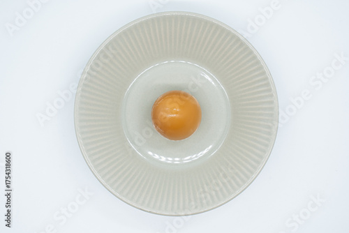 Boiled eggs in a circular bowl on a white background