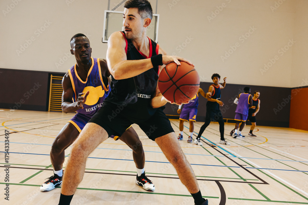 Fototapeta premium Basketball game with young male players