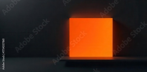 Abstract minimalist composition featuring a brightly illuminated orange rectangular surface set against a dark textured background with dramatic shadow