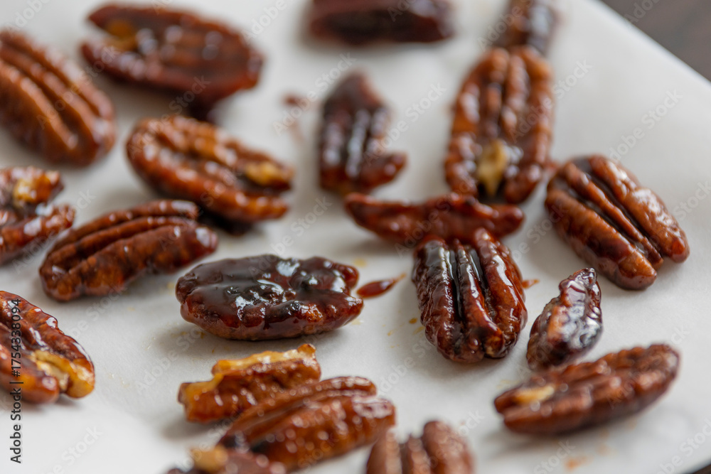 Obraz premium caramelized pecans on white background close up