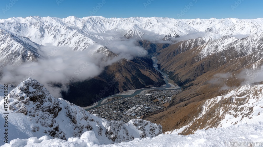 Obraz premium Snowcapped mountains provide a breathtaking view of the valley and town below, captured on a clear sunny day in the Southern Alps
