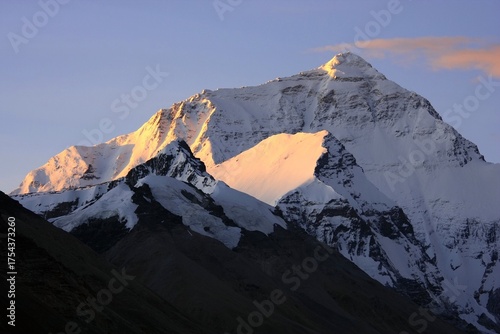 Mount Everest: Peak Emerging from Clouds in Golden Light