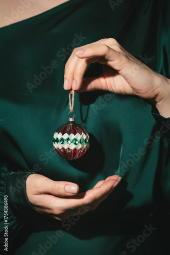 Closeup of woman's hands holding old vintage Christmas glass ornament