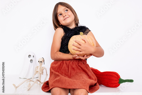 Caucasian child with pumpkin and Halloween decor