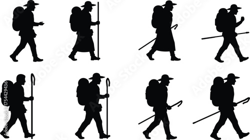 Backpacker or Pilgrim Silhouette Walking with Staff and Rucksack, Representing Hiking, Adventure Travel, Pilgrimage, and Freedom

.