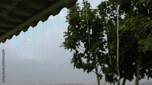 Heavy Rain with Water Pouring Down from Roof During Stormy Weather